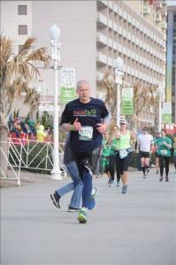Approaching finish line at Shamrock Half in Virginia Beach, eyes on ocean sunrise and going for 26.2 